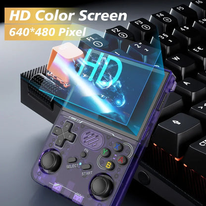 Handheld gaming console with HD color screen and keyboard in the background
